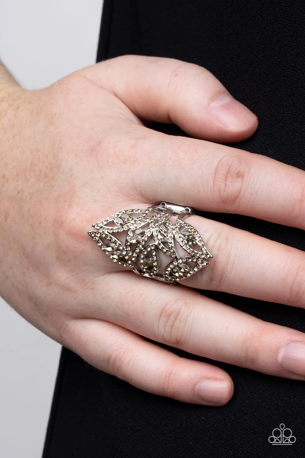 Paparazzi Accessories Fiery Foliage - Brown A glitzy collision of golden topaz marquise rhinestones floats inside golden topaz rhinestone-encrusted silver leaf-shaped frames that dance across the finger resulting in a glamorous finish. Features a stretchy