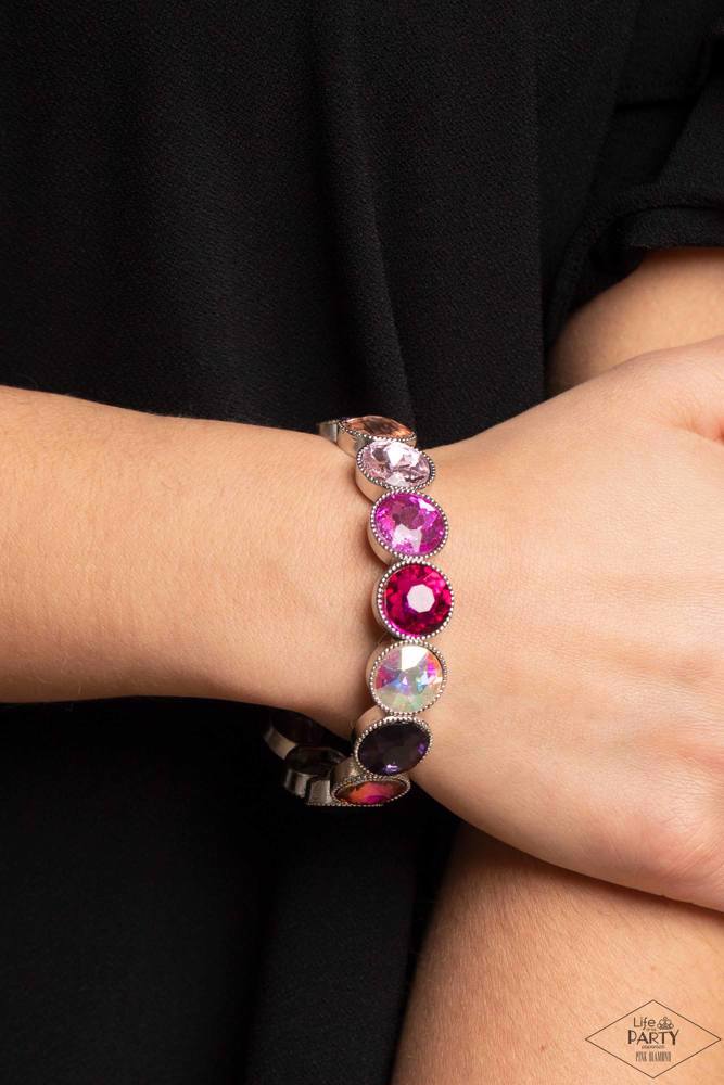 Paparazzi Accessories Number One Knockout - Multi 3 Faceted gems in colorful shades featuring varying shimmers and iridescence are pressed into sleek silver frames. The glittery frames are threaded along elastic stretchy bands, creating a glamorous look a
