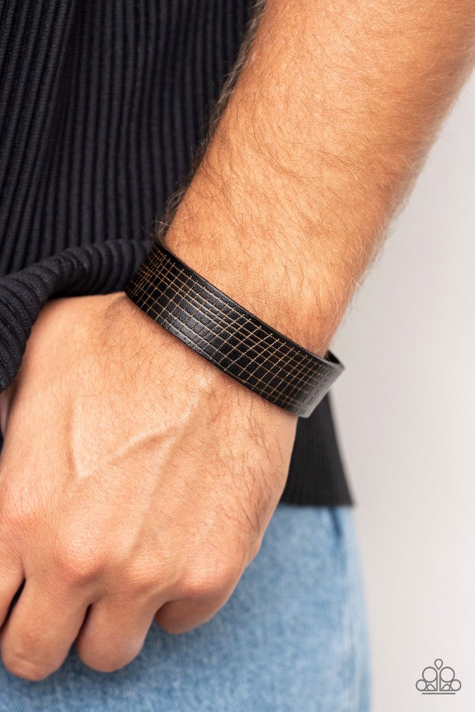 Paparazzi Accessories Rugged Reputation - Black The front of a black leather band is asymmetrically scratched in a rugged linear pattern, resulting in a rustic centerpiece around the wrist. Features an adjustable snap closure. Sold as one individual brace