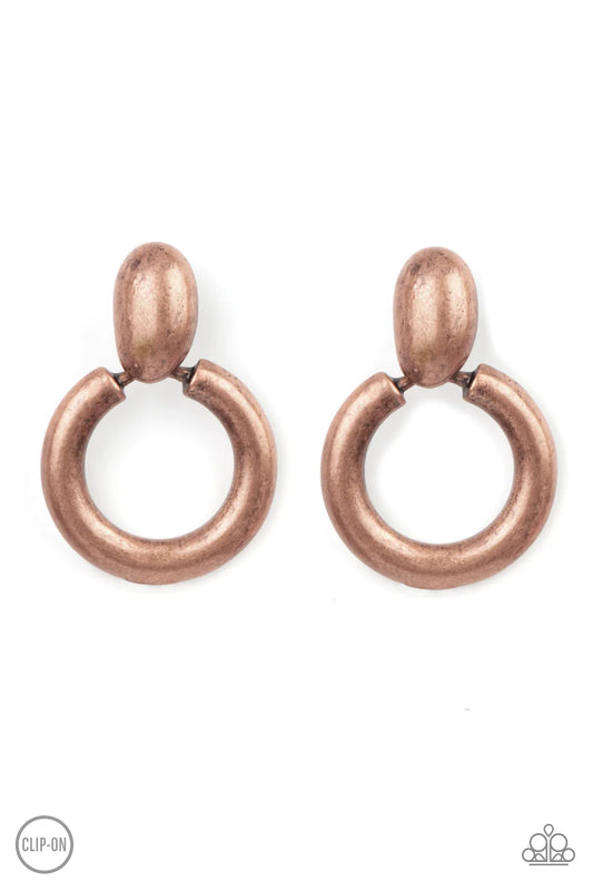 Paparazzi Accessories Ancient Artisan - Copper *Clip-On Brushed in an antiqued shimmer, a burnished copper hoop swings from the bottom of an asymmetrical copper fitting for a handcrafted flair. Earring attaches to a standard clip-on earrings. Sold as one