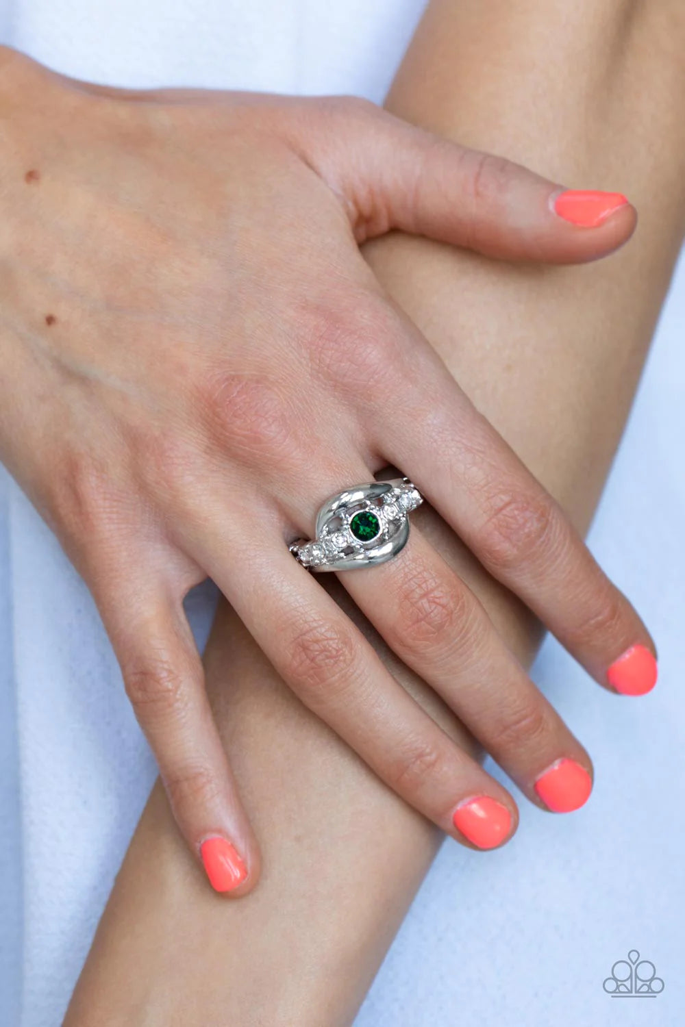 Paparazzi Accessories Graceful Gallantry - Green Swooping bands of silver nestle around a glassy band of dainty white rhinestones. A solitaire green rhinestone adorns the center of the glittery compilation, creating a timeless centerpiece atop the finger.