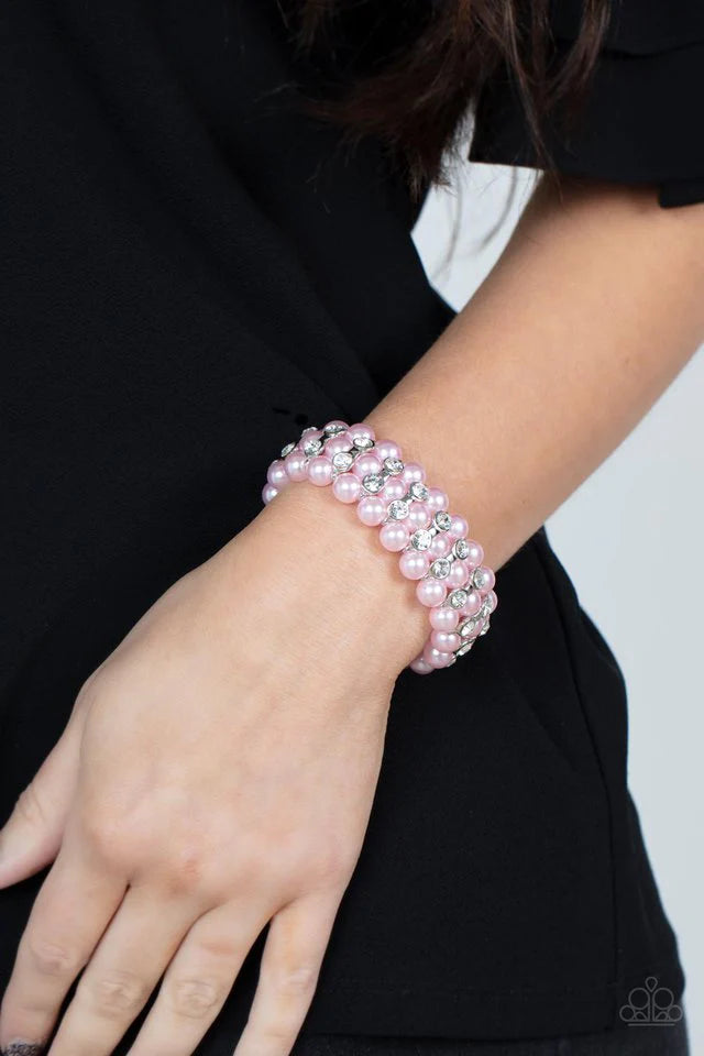 Paparazzi Accessories Eiffel Tower Elegance - Pink Stacked rows of bubbly pink pearls alternate with white rhinestone encrusted silver frames along stretchy bands, adding a timeless twist to the traditional pearl palette. Jewelry