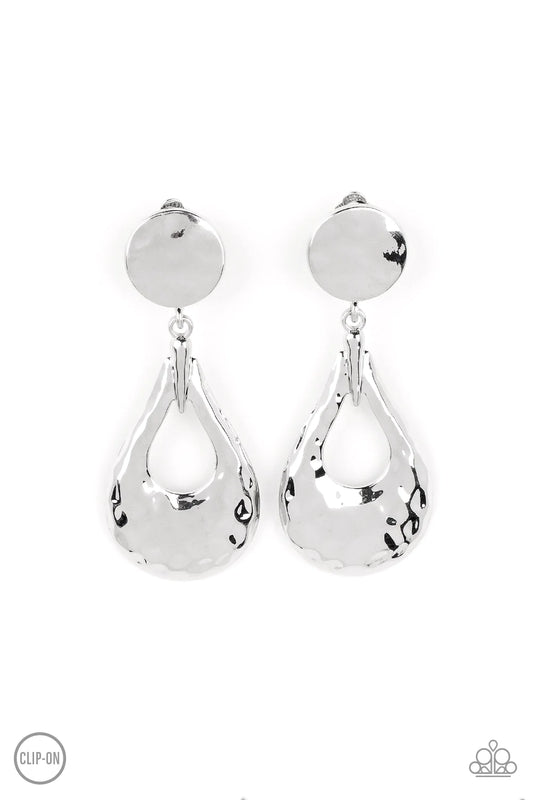 Paparazzi Accessories Metallic Magic - Silver *Clip-On A hammered silver teardrop swings from the bottom of a hammered silver disc, resulting in monochromatic magic. Earring attaches to a standard clip-on fitting. Jewelry