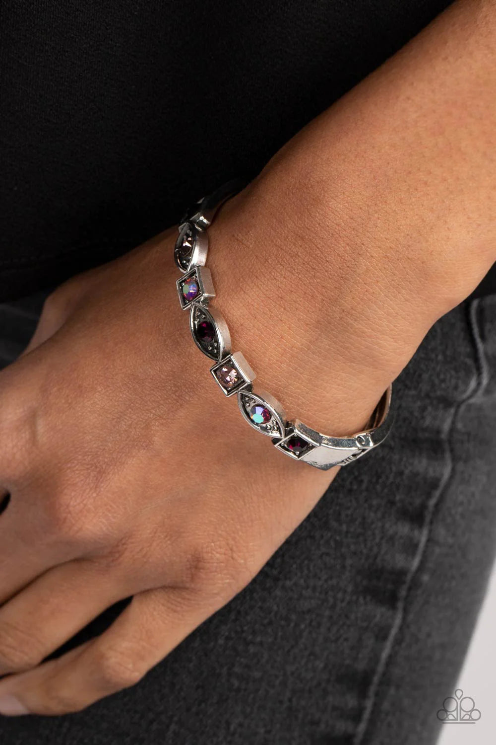 Paparazzi Accessories Poetically Picturesque - Purple A collection of square and marquise-shaped frames arc across the wrist in a stunning geometric display. Amethyst, light amethyst, and iridescent rhinestones are pressed into the centers of the thick si