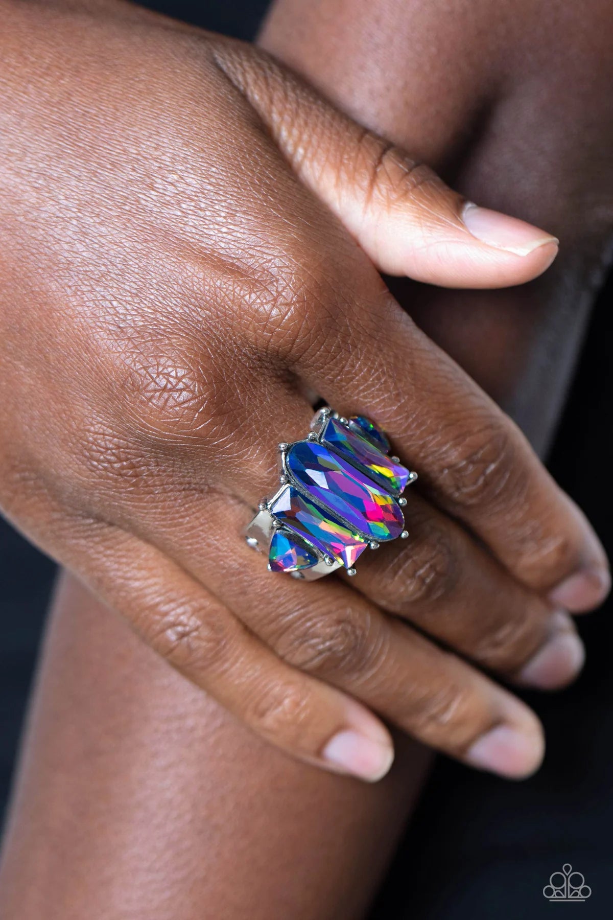 Paparazzi Accessories Iridescently Interstellar - Multi Featuring a stellar UV finish, an iridescent collection of triangular, emerald, and oval cut rhinestones are encrusted across the center of a thick silver band for an out-of-this-world fashion. Featu
