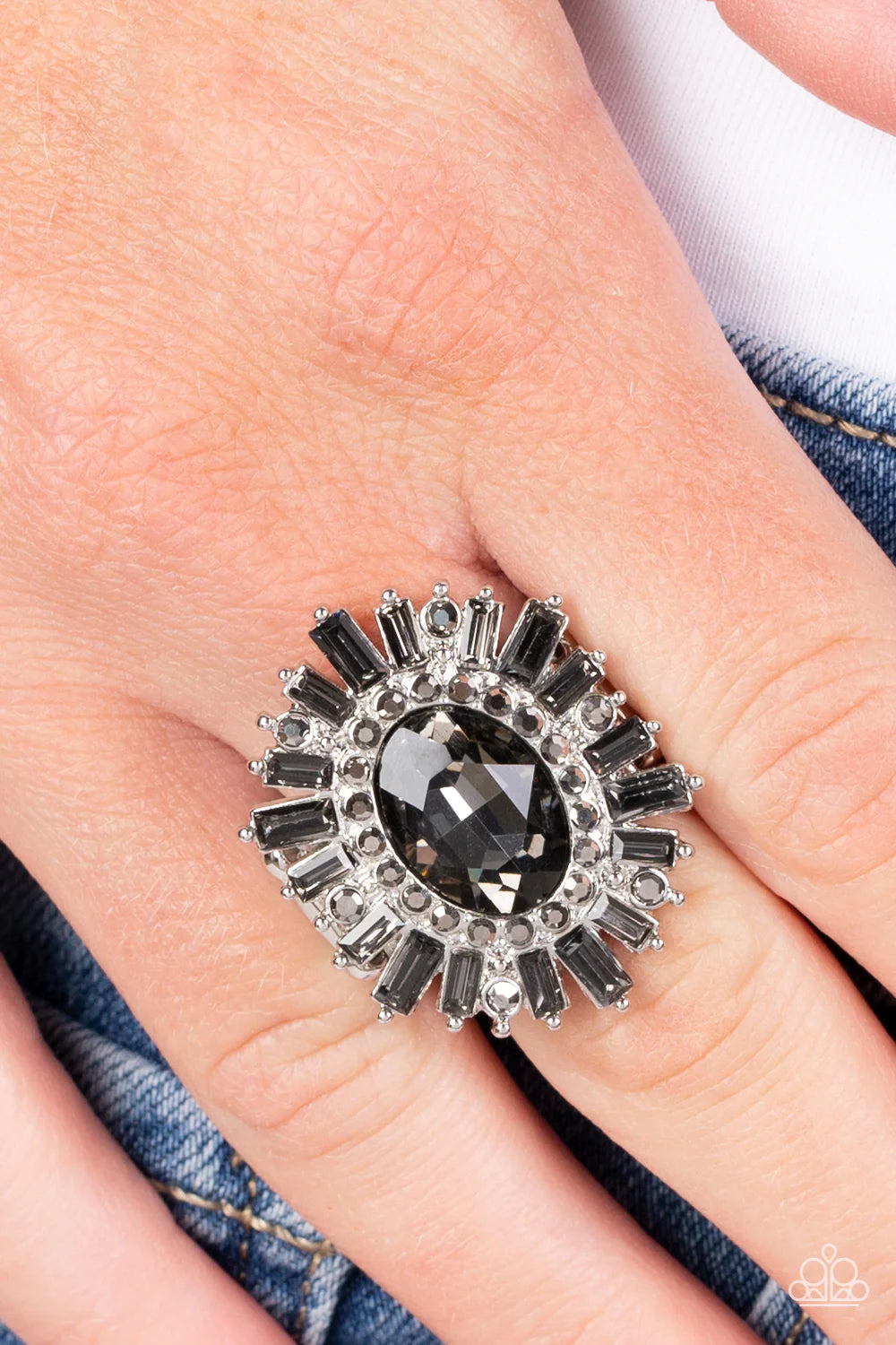 Paparazzi Accessories Astral Attitude - Silver A large smoky rhinestone sparkles inside a ring of dainty hematite rhinestones. Emerald cut hematite and smoky gray rhinestones fan out from the dazzling center, exploding into a stellar centerpiece atop the