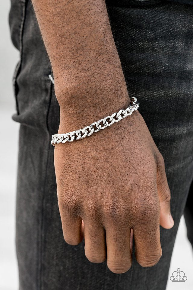 Paparazzi Accessories Take It To The Bank - Silver Featuring classic curb link chain, a thick silver chain wraps around the wrist for a sleek, metro look. Features an adjustable clasp closure. Jewelry