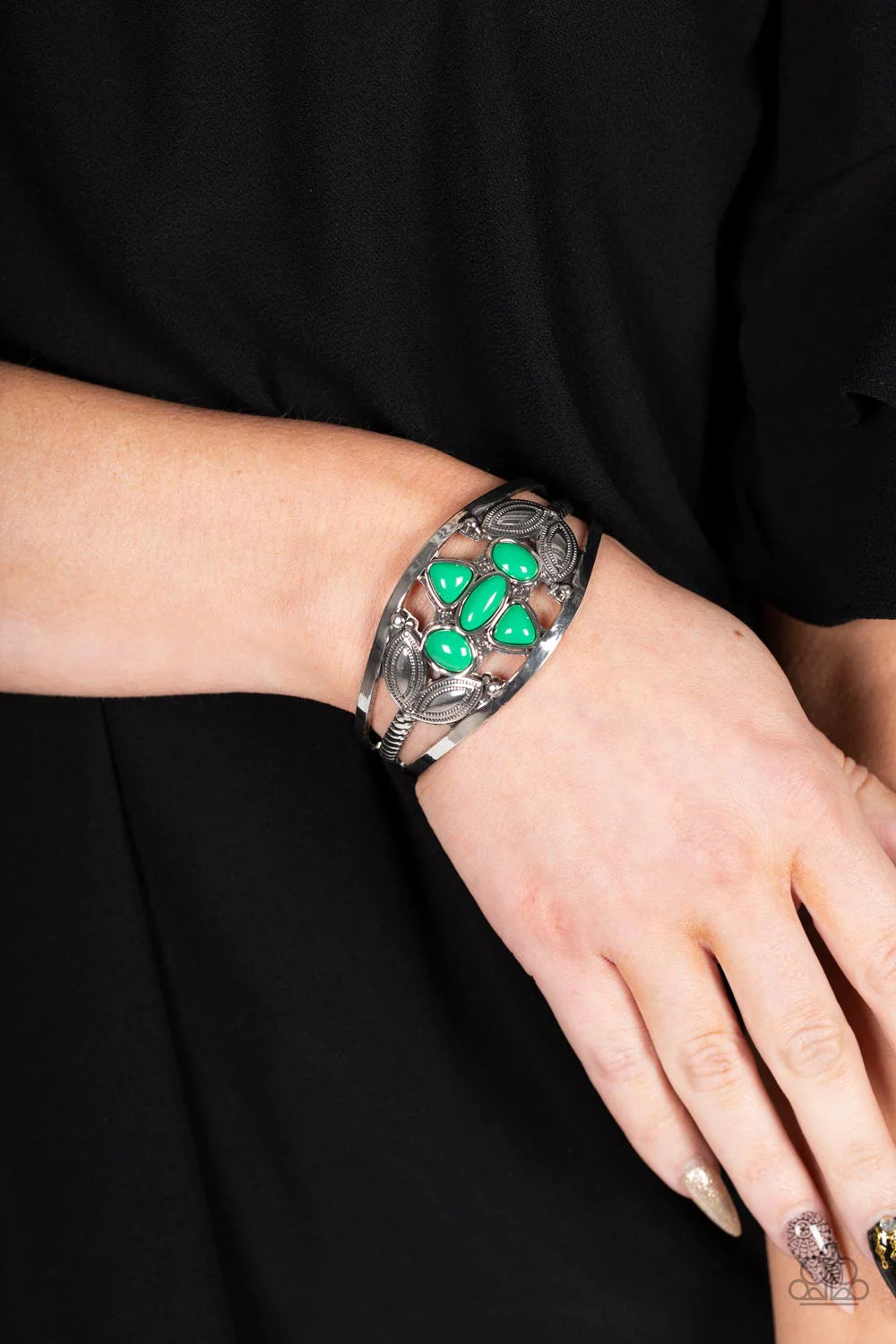 Paparazzi Accessories Caribbean Cabana - Green A shapely assortment of Leprechaun acrylic beads adorn the center of a layered silver cuff adorned in leafy silver texture, creating a refreshing pop of color around the wrist. Sold as one individual bracelet