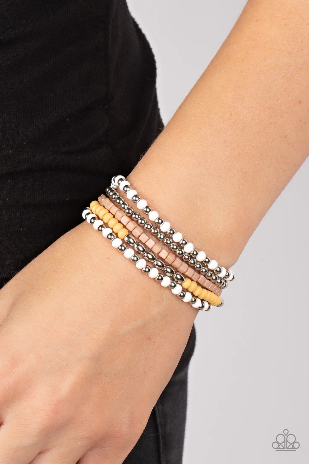 Paparazzi Accessories Adventure is Calling - Brown Featuring the neutral shades of white, brown, silver, and Daffodil, an adventurous assortment of round and cube beads are threaded along stretchy bands around the wrist for a colorfully layered look. Jewe