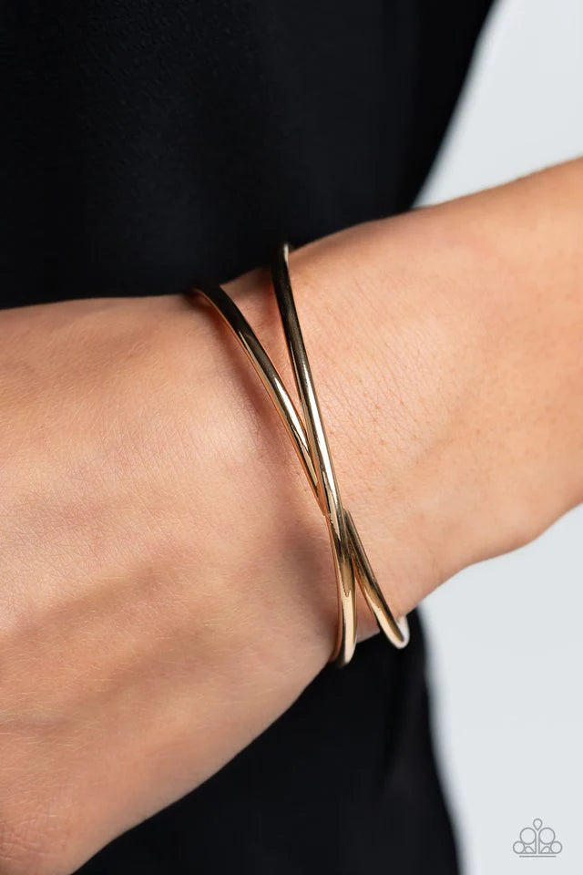 Paparazzi Accessories Teasing Twist - Gold High-sheen gold bars twist across the center of an airy cuff, coalescing into a minimalist statement around the wrist. Sold as one individual bracelet. Jewelry