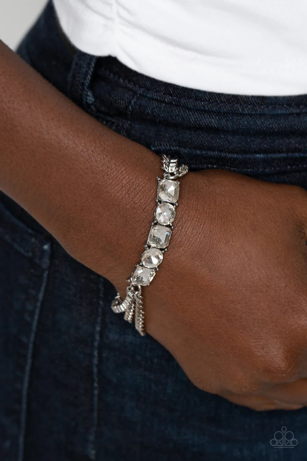 Paparazzi Accessories Tyrant Treasure - White A gritty mix of classic silver and silver box-chains stem from a row of faceted white gems, pressed into circular and square silver frames, creating edgy layers around the wrist. Features an adjustable clasp c