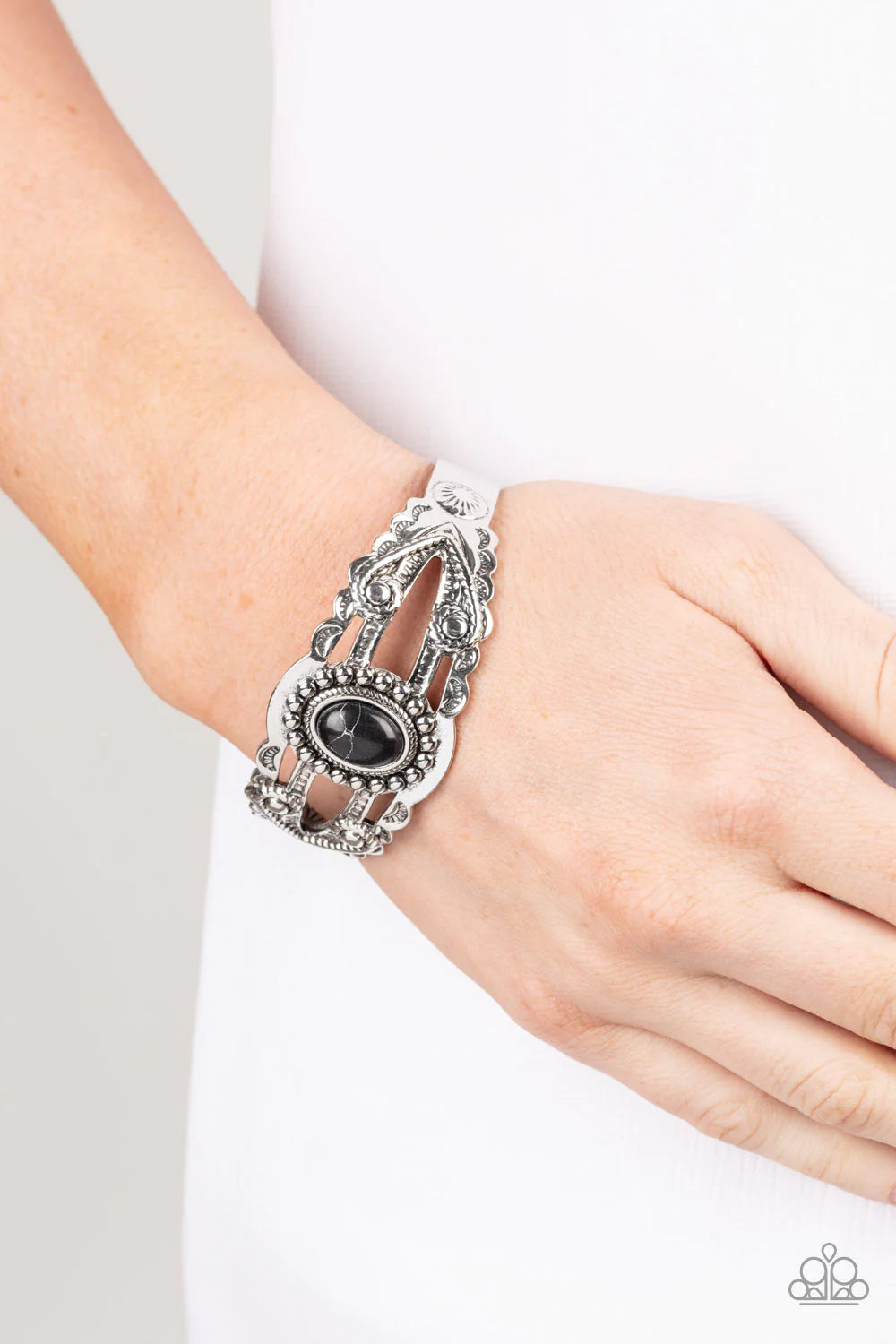 Paparazzi Accessories Sonoran Soul Searcher - Black An oval black stone is pressed into the center of an ornately layered silver cuff that is stamped and embossed in floral and tribal inspired patterns, creating a seasonal pop of color around the wrist. S