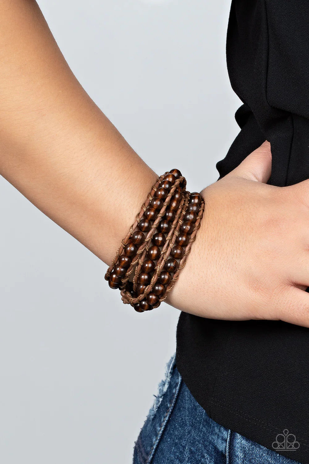Paparazzi Accessories Pine Paradise - Brown A row of brown wooden beads are knotted in place along two brown leather cords, creating multiple earthy layers around the wrist with its extended length. Features an adjustable button loop closure. Sold as one