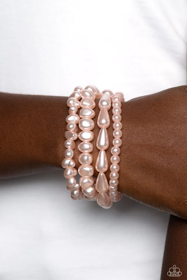 Paparazzi Accessories Gossip PEARL - Pink An abstract collection of geometric baby pink pearls coalesces around the wrist in four layers on elastic stretchy bands for a fashionably, refined stack. Sold as one set of four paparazzi bracelets. Jewelry