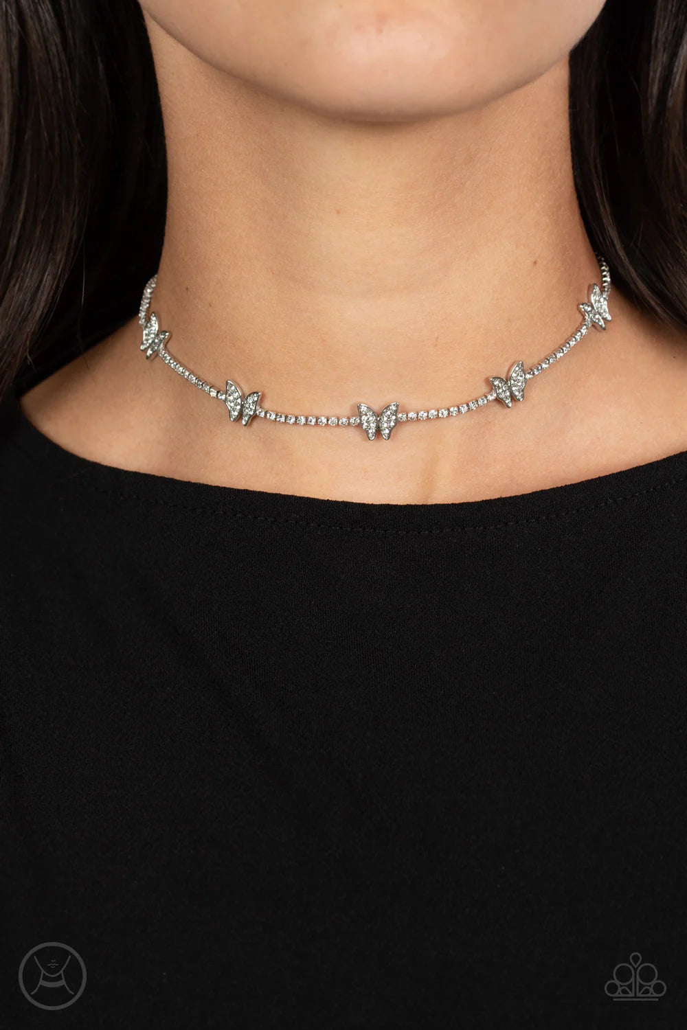 Paparazzi Accessories Fluttering Fanatic - White Infused along a row of dainty white rhinestones pressed into silver box-chain settings, a collection of silver butterflies coalesces around the neckline for a whimsical finish. Each butterfly features a dai