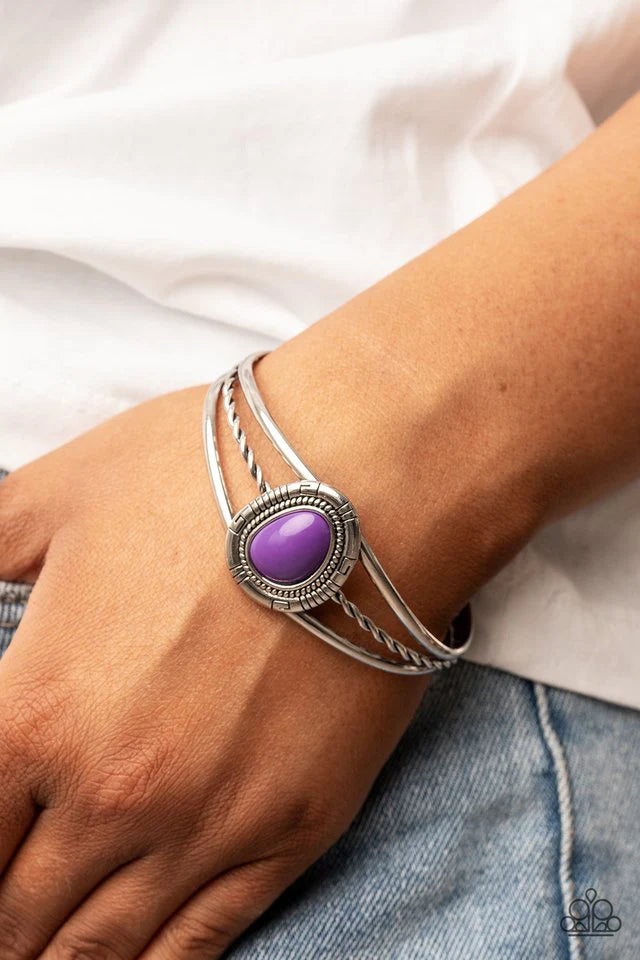 Paparazzi Accessories Ethereal Enthusiast - Purple An asymmetrical purple bead is encircled with a textured silver frame atop a decorative silver cuff, resulting in a colorful tribal inspired centerpiece around the wrist. Jewelry