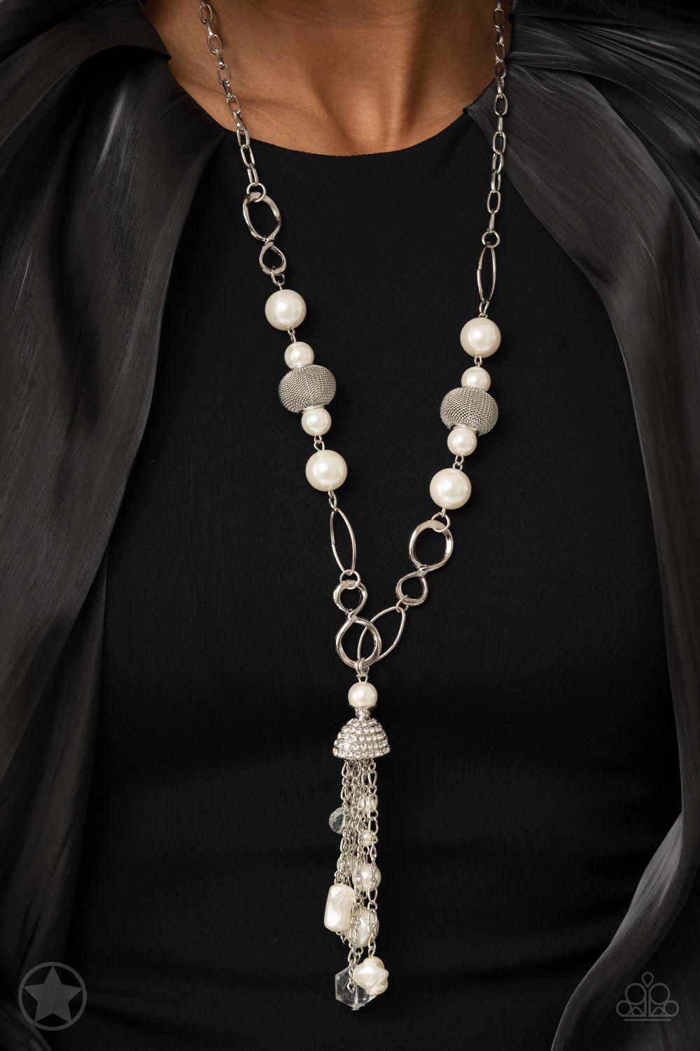 Paparazzi Accessories Designated Diva - White A half-shell studded in rhinestones overhangs a cluster of ivory pearls, tassels of silver chain, and small crystals. Two large wire mesh spheres and larger ivory pearls decorate the neckline. Sold as one indi