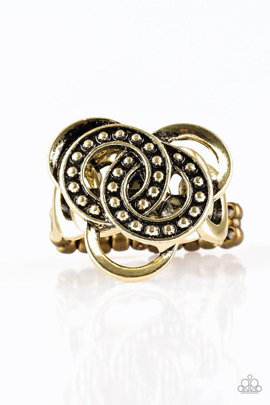 Paparazzi Accessories Dizzying Distraction - Brass Dotted in shimmery brass studs, antiqued rings sit atop a dizzying brass backdrop for an edgy geometric look. Features a dainty stretchy band for a flexible fit. Sold as one individual ring. Jewelry