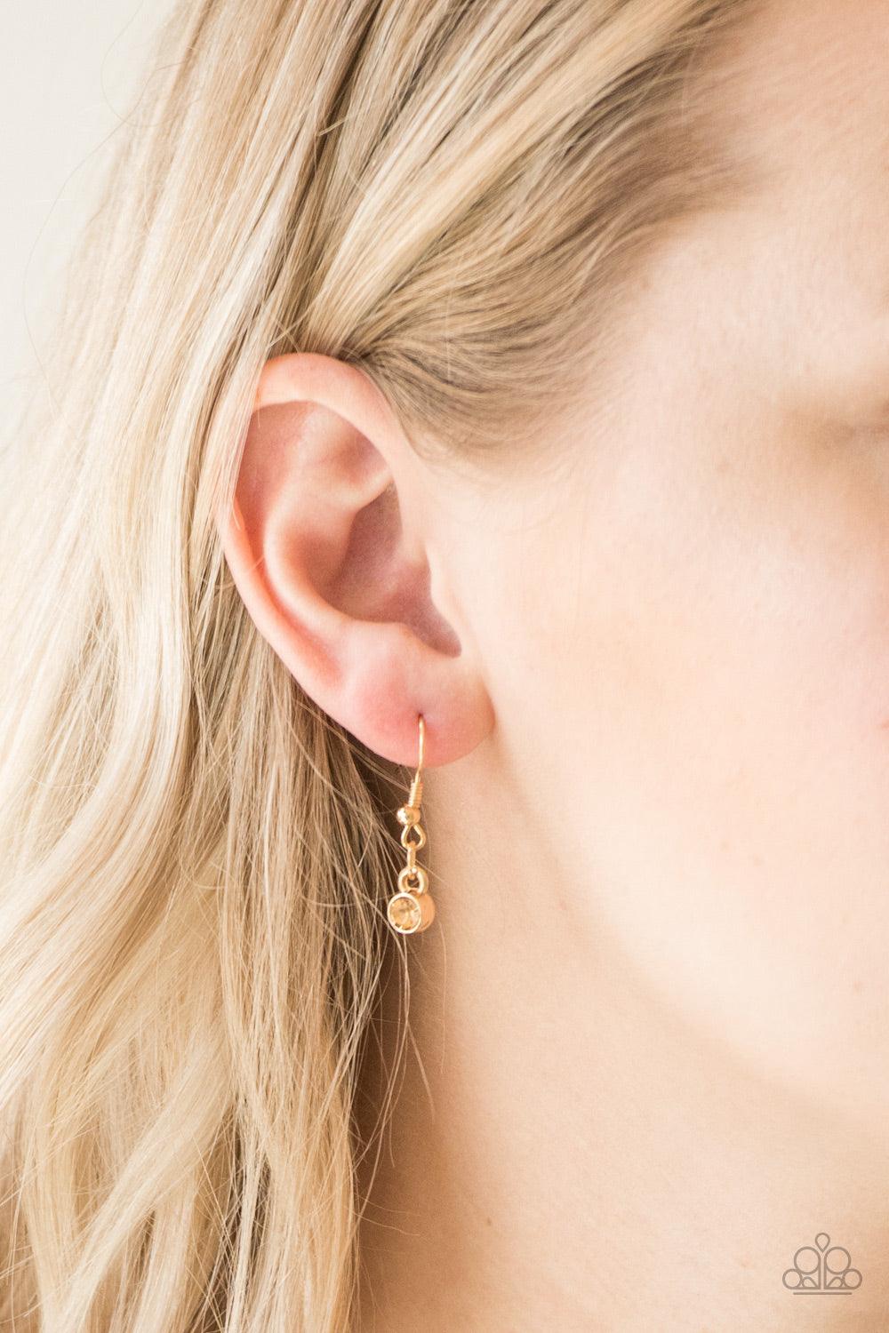 Paparazzi Accessories The Imperfectionist - Gold Featuring shimmery gold frames, imperfect golden gems link below the collar for a glamorous vintage inspired look. Features an adjustable clasp closure. Sold as one individual necklace. Includes one pair of