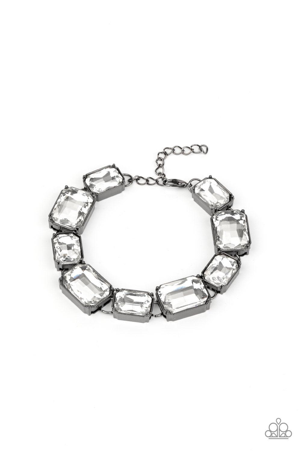 Paparazzi Accessories After Hours - Black Encased in sleek gunmetal fittings, a regal chain of small and large white emerald style gems alternate along the wrist for a timeless finish. Features an adjustable clasp closure. Sold as one individual bracelet.