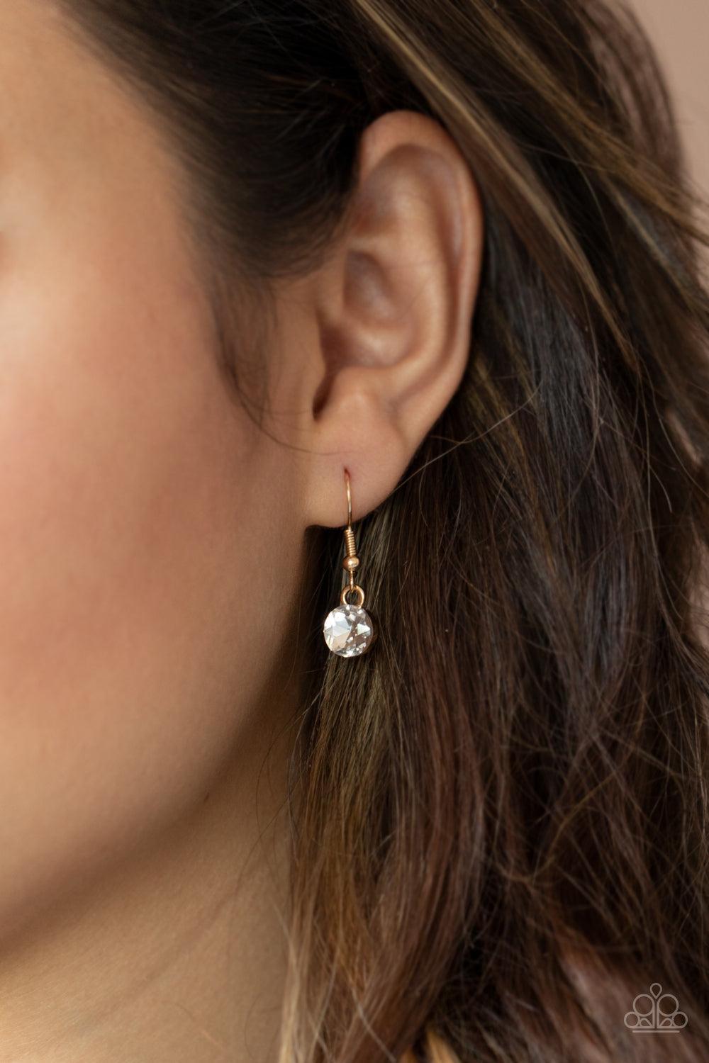 Paparazzi Accessories Celebrity Couture - Gold Glittery stacks of glassy white rhinestones gradually increase in size as they drip from the bottom of a classic gold chain, creating a blinding fringe below the collar. Features an adjustable clasp closure.