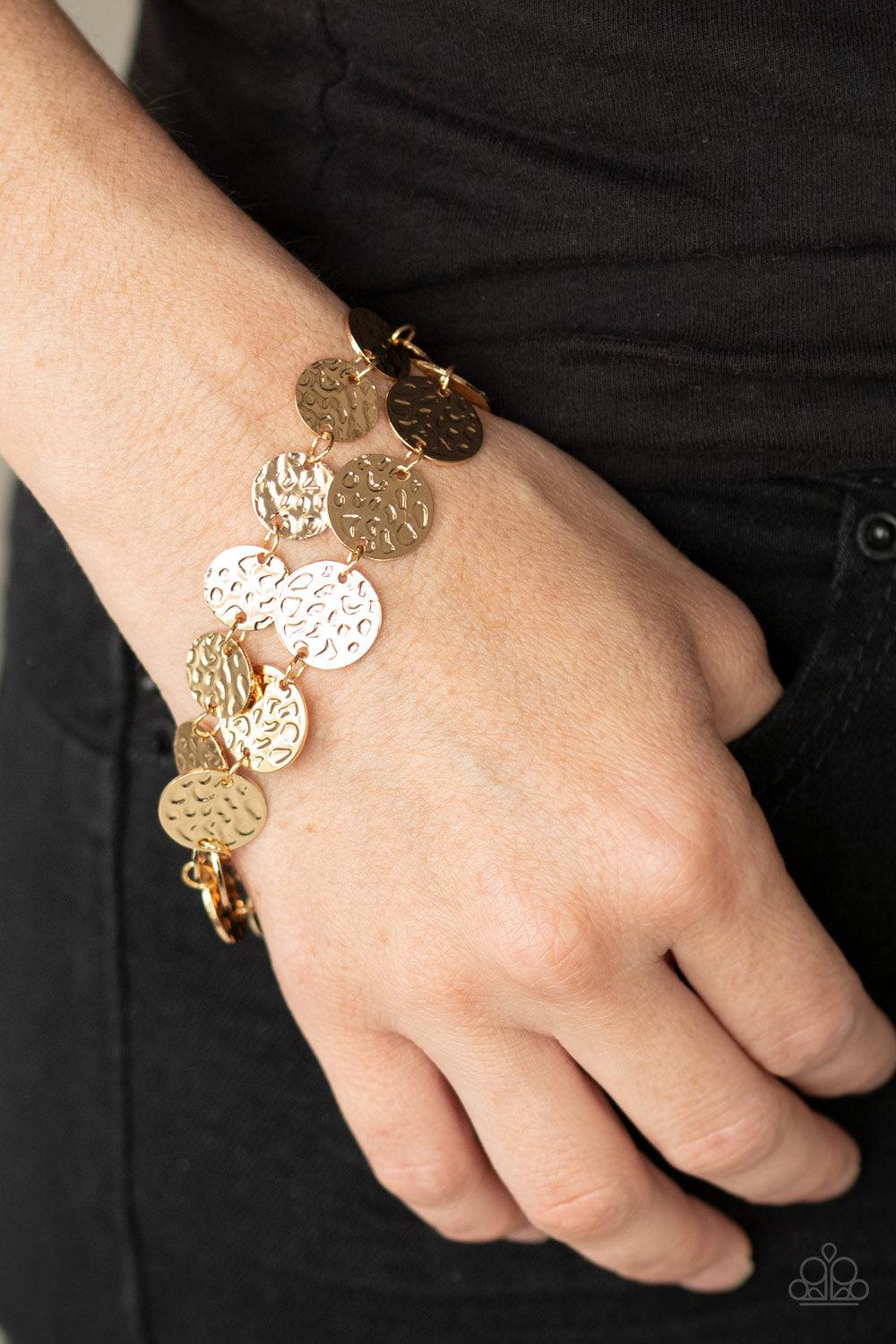 Paparazzi Accessories Rooted To The SPOTLIGHT - Gold Two rows of hammered gold discs wrap around the wrist, creating an edgy shimmer. Features an adjustable clasp closure. Sold as one individual bracelet. Get The Complete Look! Necklace: "Spotlight Ready