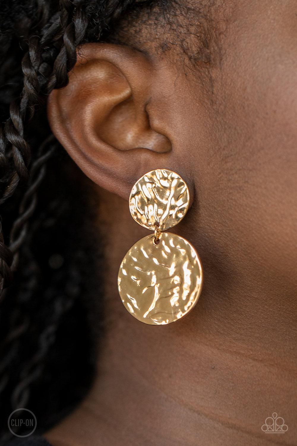 Paparazzi Accessories Relic Ripple - Gold *Clip-On Varying in size, hammered gold discs link into a rippling lure. Earring attaches to a standard clip-on fitting. Sold as one pair of clip-on earrings. Jewelry