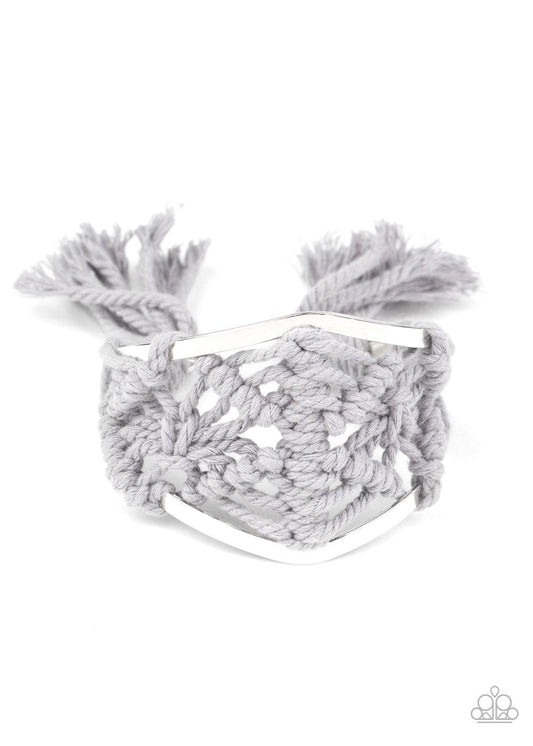 Paparazzi Accessories Macrame Mode - Silver Ash cording decoratively knots and weaves around an airy silver cuff for a macramé inspired look. Knotted around the ends, Ash tassels flair out from the bottoms of the cuff for a wanderlust finish. Sold as one