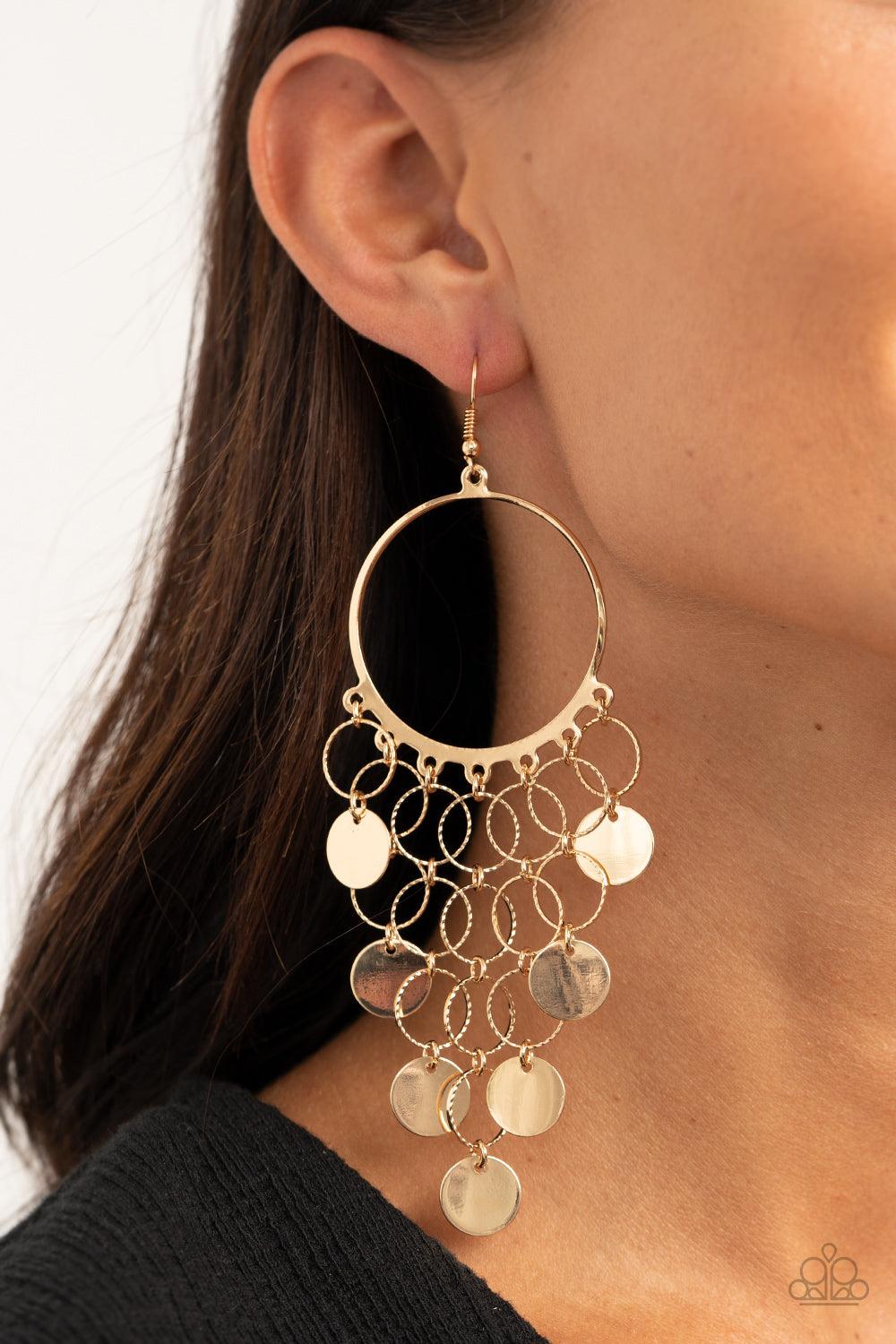 Paparazzi Accessories Take a CHIME Out - Gold Chains of textured gold hoops and flat gold discs cascade from the bottom of a glistening gold hoop, creating a timelessly tapered fringe. Earring attaches to a standard fishhook fitting. Sold as one pair of e