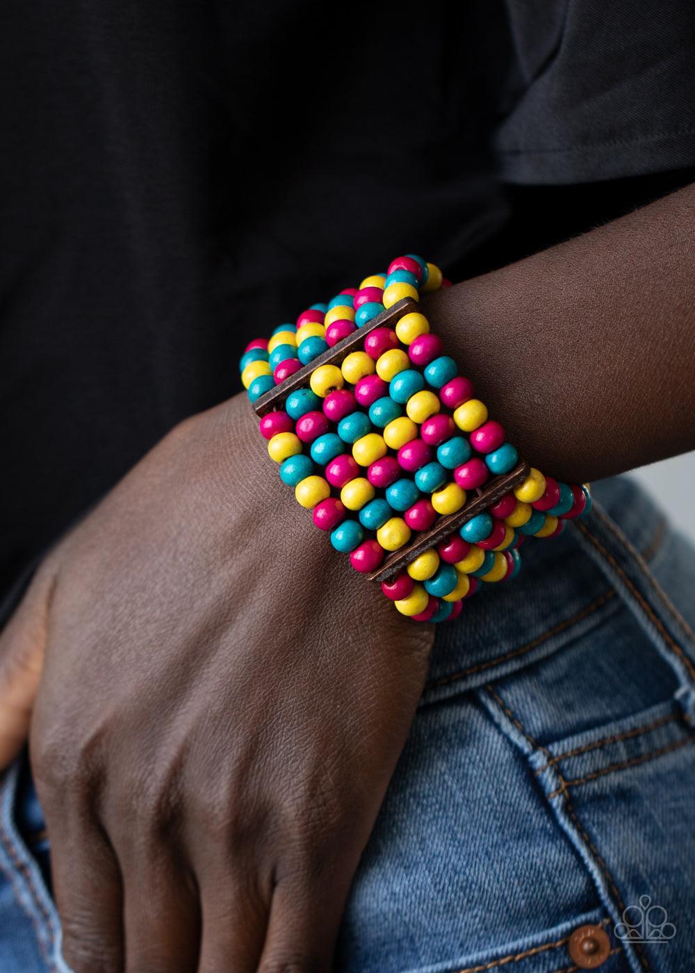 Paparazzi Accessories Tanning in Tanzania - Multi Held together with rectangular wooden fittings, strands of vivacious pink, yellow, and blue wooden beads are threaded along stretchy bands that layer around the wrist into one colorful stretch bracelet. So