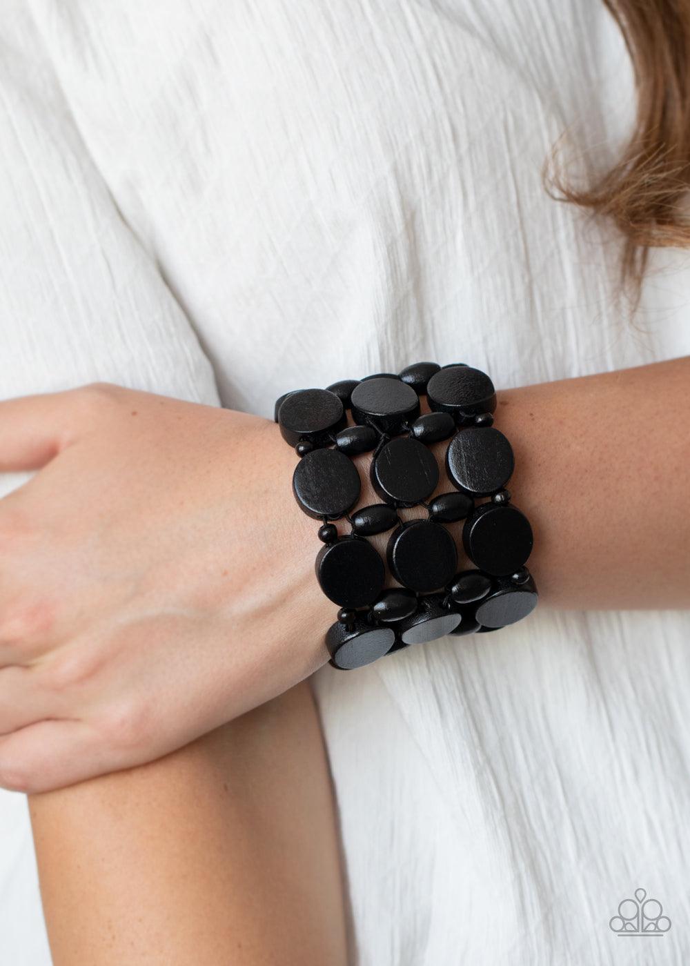 Paparazzi Accessories Cruising Coronado - Black Featuring disc, oval, and rounded shapes, a mismatched collection of shiny black wooden beads are threaded along knotted stretchy strands, creating a tropical inspired look around the wrist. Sold as one indi