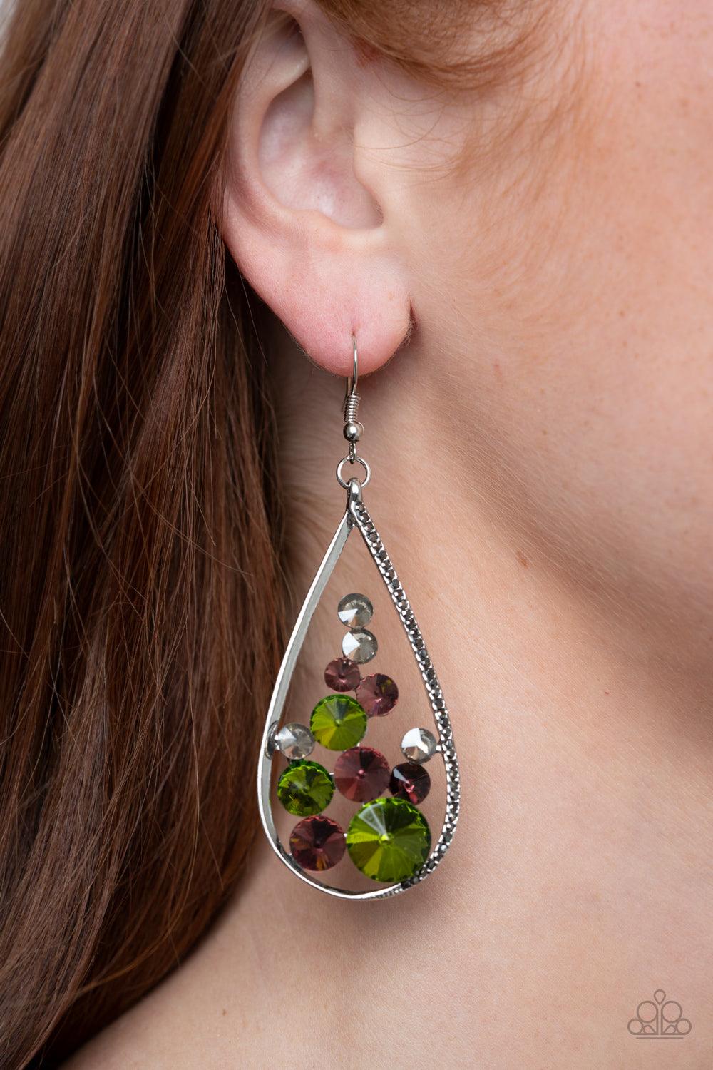 Paparazzi Accessories Tempest Twinkle - Multi An oversized collection of glittery purple, green, and smoky rhinestones collect inside a shimmery silver teardrop. One side of the frame is encrusted in dainty hematite rhinestones, adding an elegant edge to
