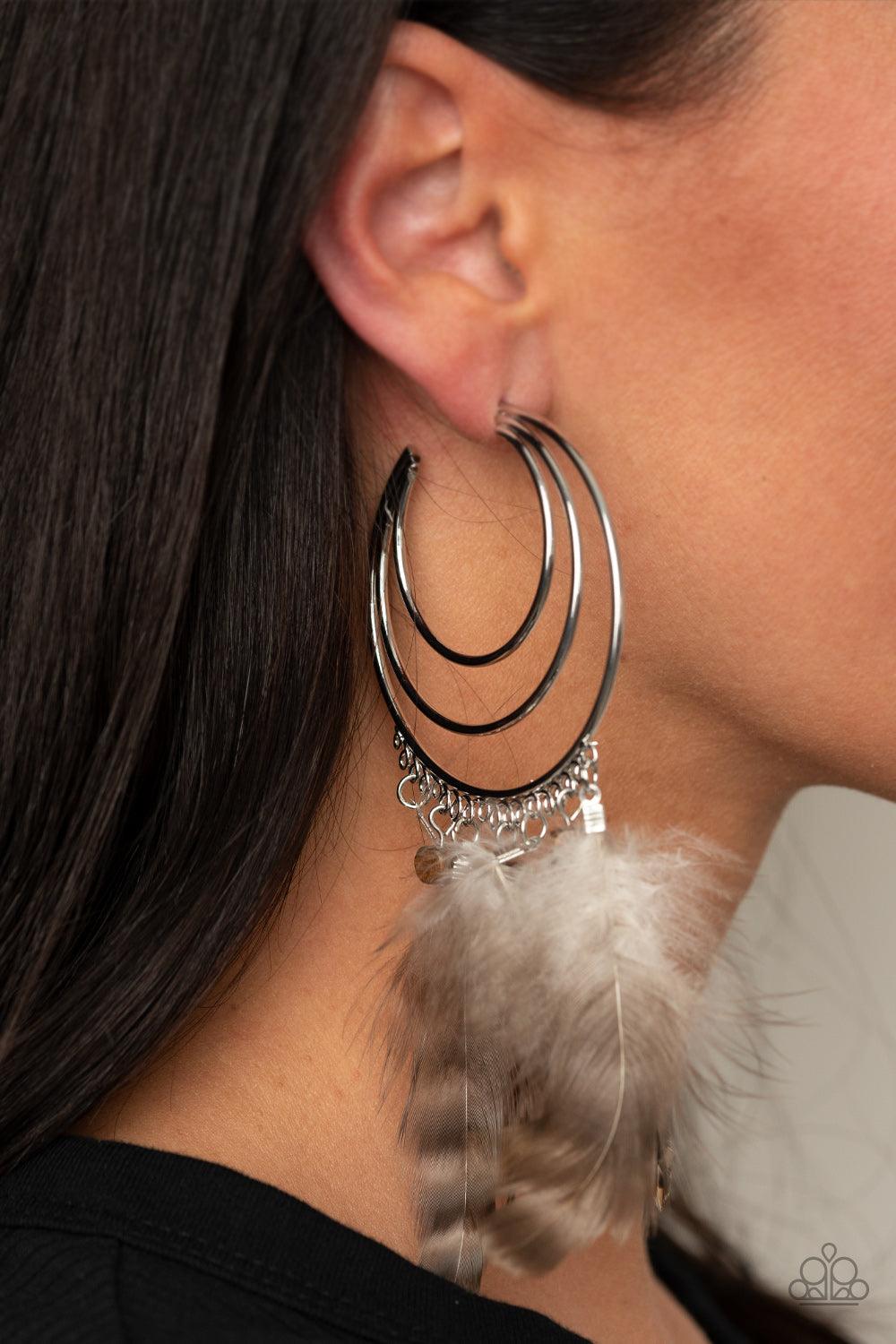 Paparazzi Accessories Freely Free Bird - Brown Whimsical feathers and wooden cube beads swing from the outer edge of a layered silver hoop that ripples out into an airy crescent. Earring attaches to a standard post fitting. Hoop measures approximately 2 1