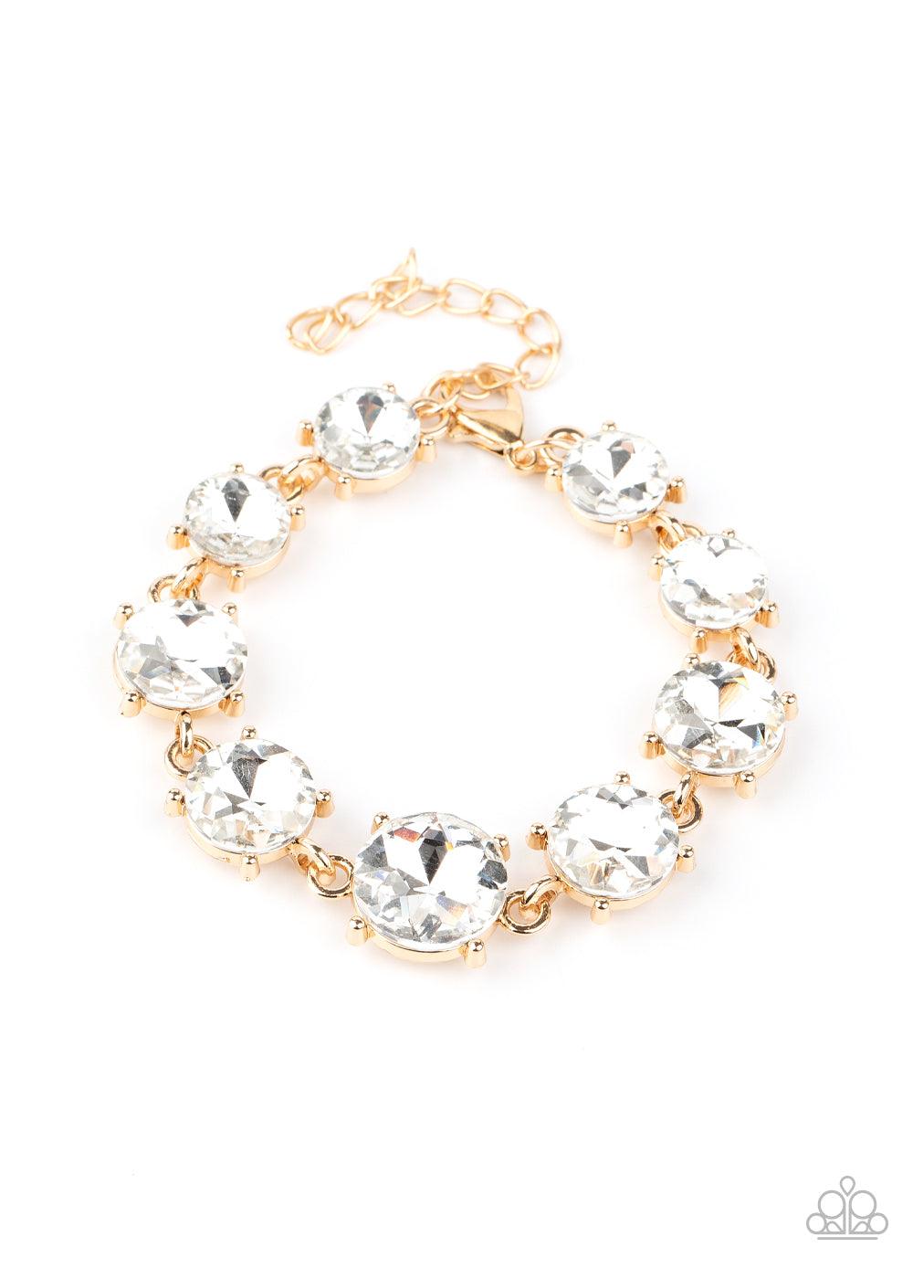 Paparazzi Accessories Cant Believe My ICE - Gold Gradually increasing in size at the center, a dramatic row of exaggerated white rhinestone encrusted gold frames delicately link around the wrist for a statement-making sparkle. Features an adjustable clasp