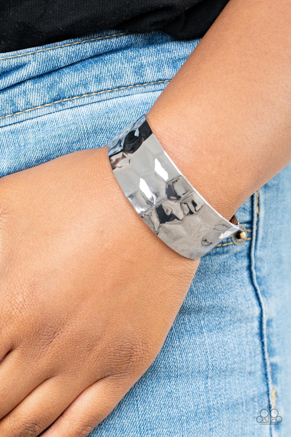 Paparazzi Accessories Is It HAUTE In Here? - Silver Hammered in edgy geometric detail, a shimmery silver cuff curls around the wrist for a bold pop of industrial inspiration. Sold as one individual bracelet. Jewelry