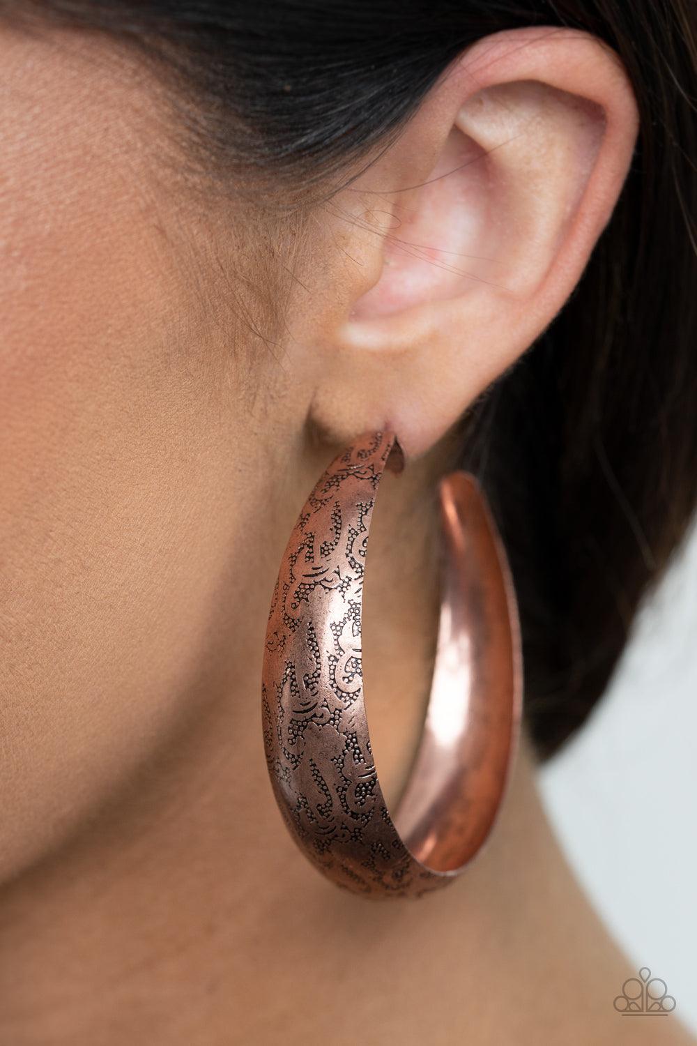 Paparazzi Accessories Sahara Sandstorm - Copper Delicately hammered in studded-like patterns, an oversized antiqued copper hoop boldly curls around the ear for a whimsically rustic look. Earring attaches to a standard post fitting. Hoop measures approxima