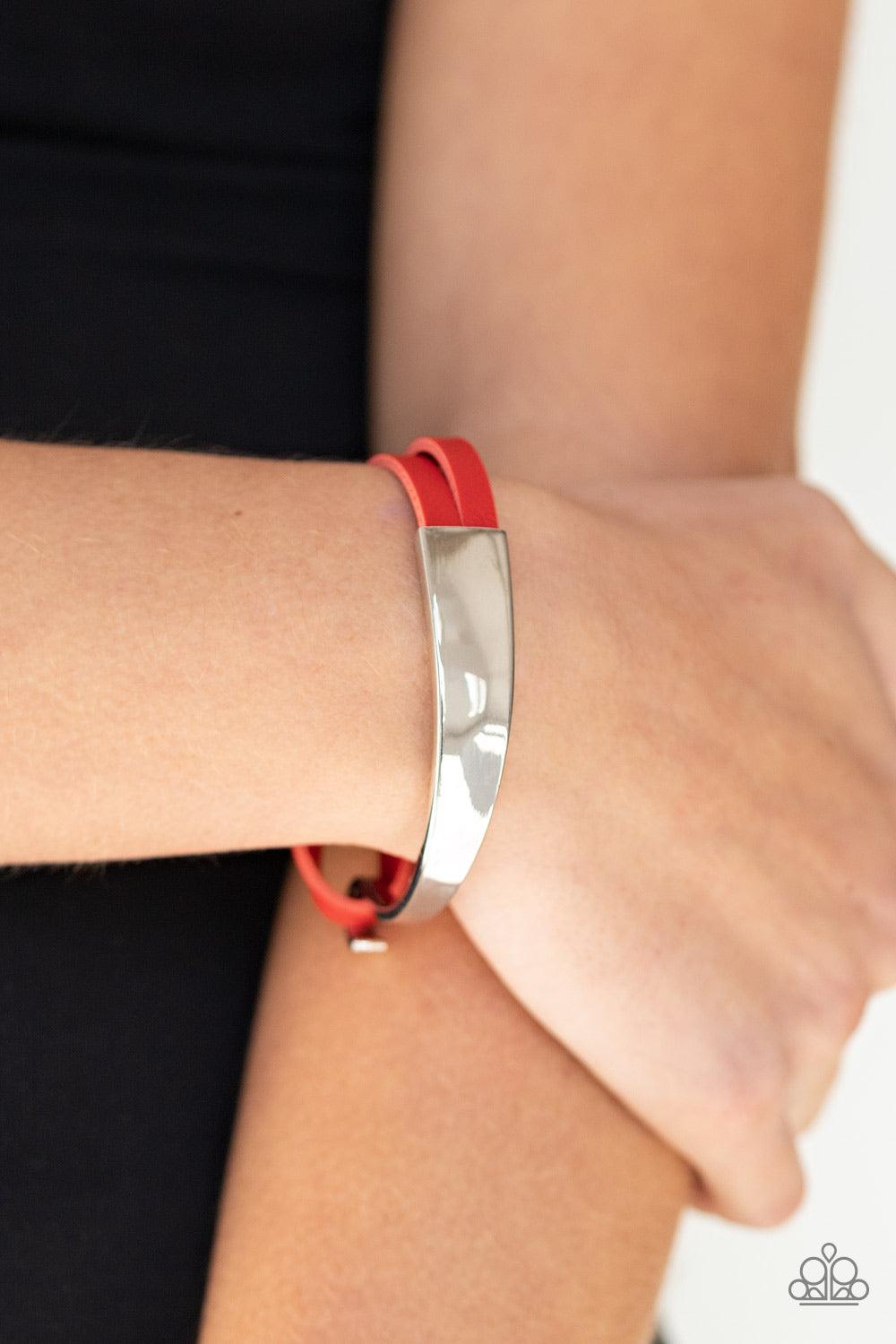 Paparazzi Accessories A Notch Above The Rest - Red A hammered silver bead glides along two strands of red leather that attach to an asymmetrical silver bar that curls out into a hook. Features a hook closure. Sold as one individual bracelet. Jewelry