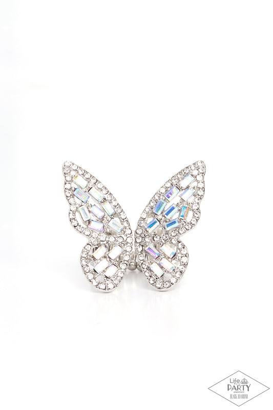 Paparazzi Accessories Flauntable Flutter - Multi Dainty iridescent emerald style rhinestones are sprinkled across the wings of a silver butterfly that is encrusted in glassy white rhinestones for a dramatically dazzling finish. Features a stretchy band fo