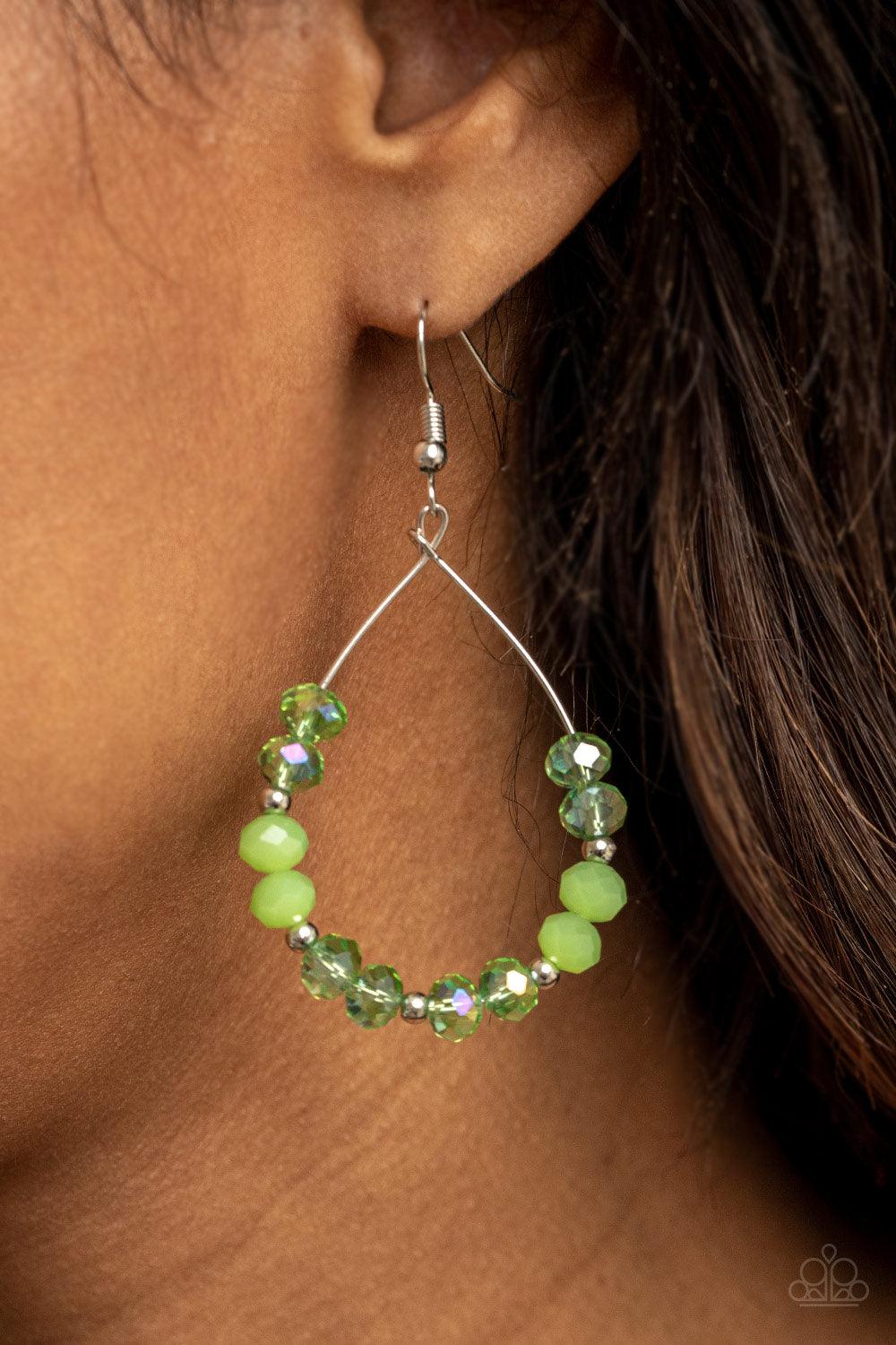 Paparazzi Accessories Wink Wink - Green Infused with dainty silver beads, a sparkly collection of glassy and opalescent green crystal-like beads glide along a dainty silver wire, coalescing into a twinkly teardrop. Earring attaches to a standard fishhook