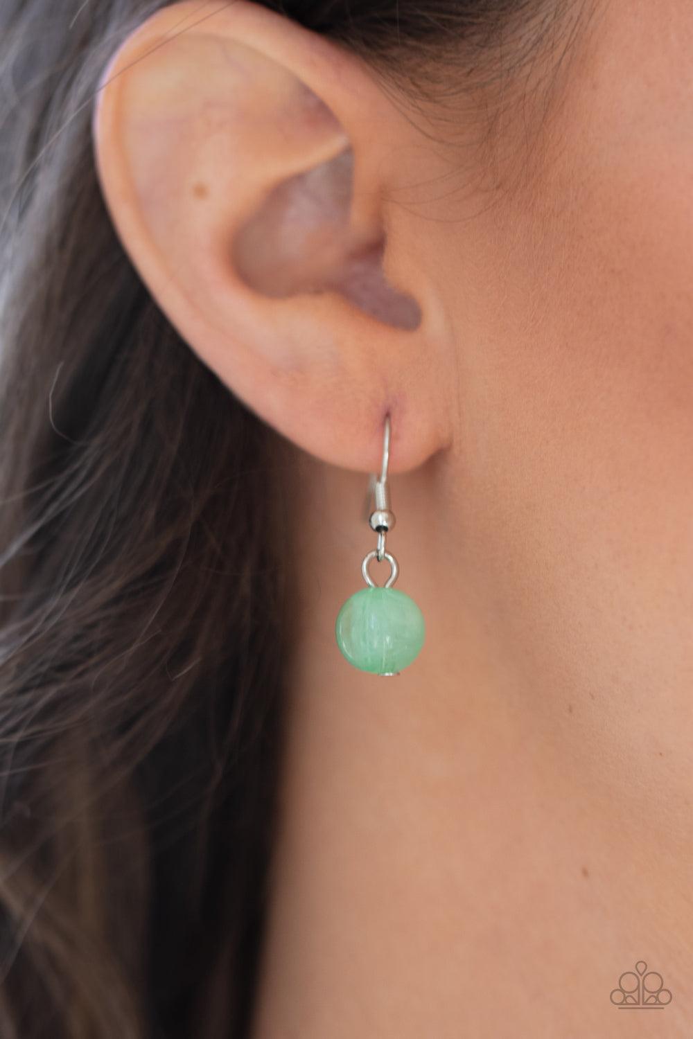 Paparazzi Accessories Spring Goddess - Green Infused with wooden beads and silver discs, an earthy collection of glassy, opaque, and shell-like Green Ash beads swing from two silver chains. The refreshing display effortlessly layers below the collar, crea