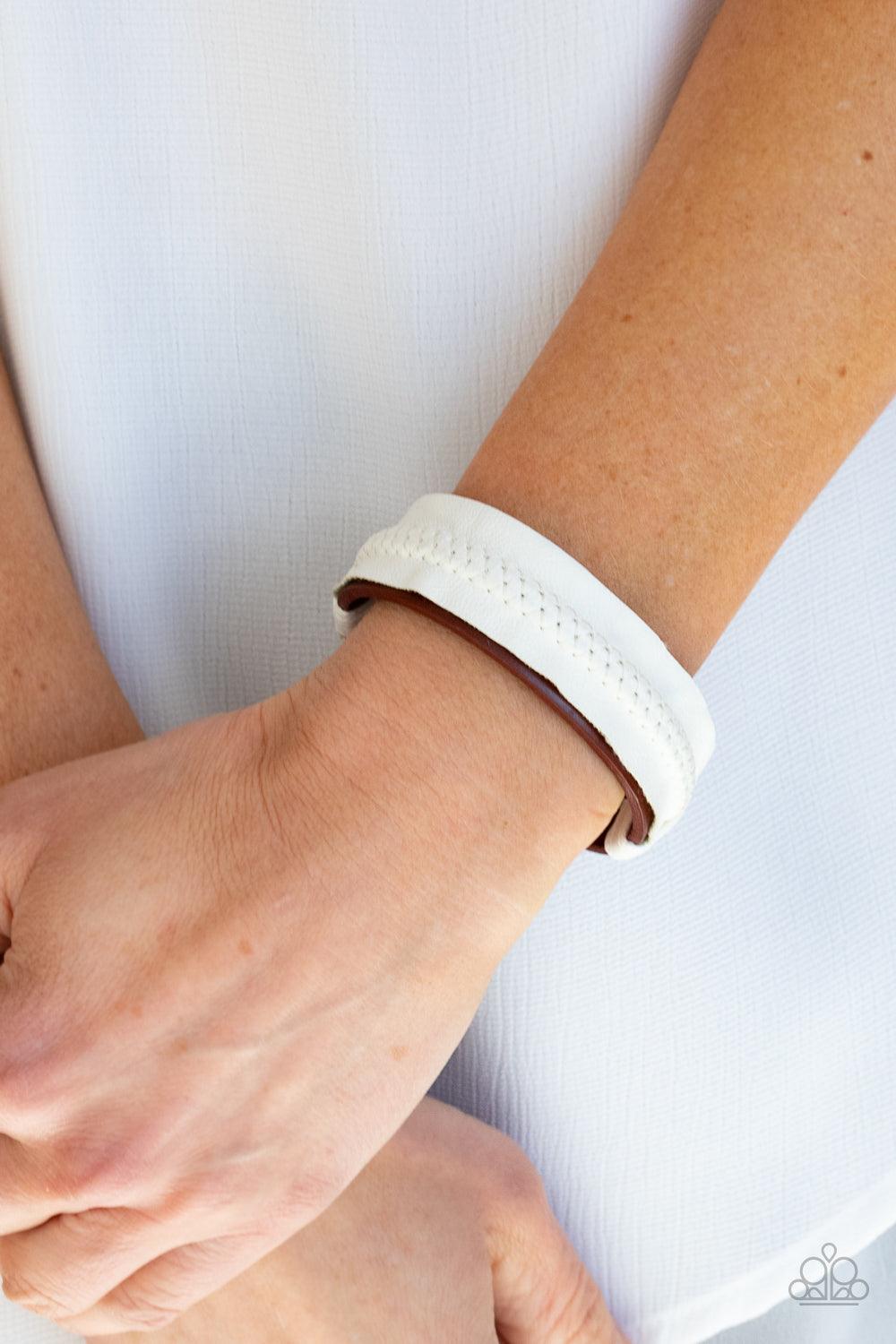 Paparazzi Accessories Country Craft Time - White Featuring tactile stitching down the center, a white piece of vinyl-like leather is knotted in place across the front of a red leather band, creating a one-of-a-kind centerpiece around the wrist. Features a