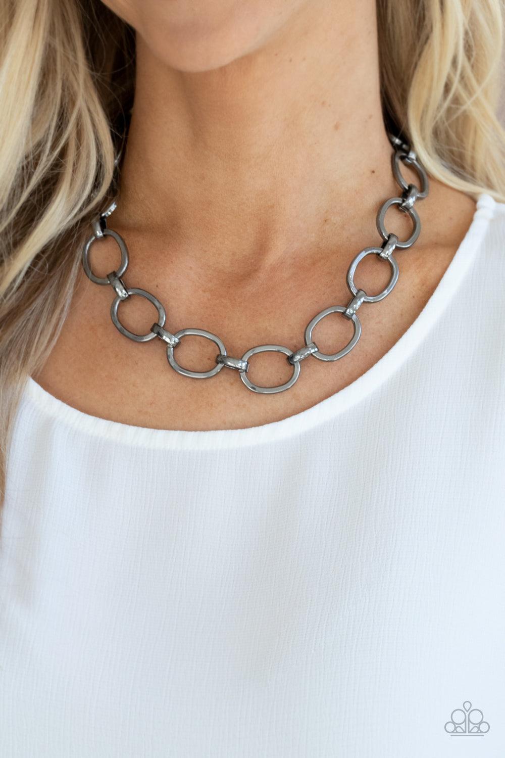 Paparazzi Accessories HAUTE-ly Contested - Black A glistening series of dramatically oversized ovals and links boldly connect below the collar, creating an intense industrial statement. Features an adjustable clasp closure. Sold as one individual necklace