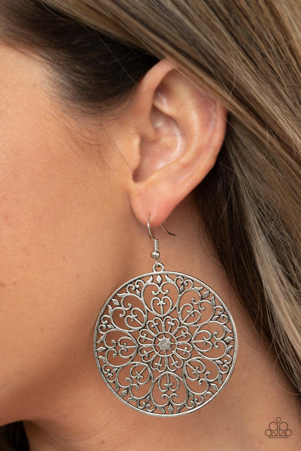 Paparazzi Accessories Make A MANDALA Out Of You - Silver Decorative silver filigree fills the center of a silver hoop, creating a whimsical mandala pattern. Earring attaches to a standard fishhook fitting. Sold as one pair of earrings. Jewelry