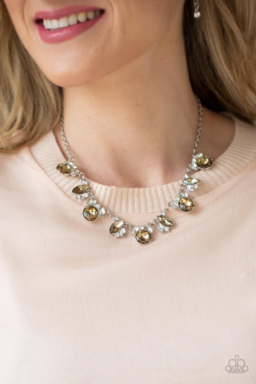 Paparazzi Accessories BLING to Attention - Brown A timeless array of round and marquise-cut white and golden topaz rhinestones delicately link into a collection of sparkly clusters, creating a scattered shimmer below the collar. Features an adjustable cla