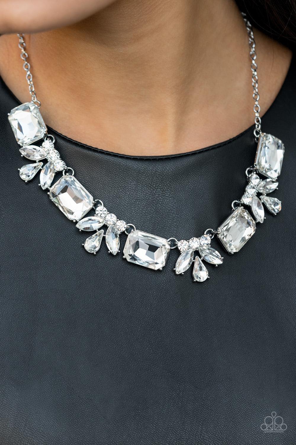 Paparazzi Accessories Long Live Sparkle - White An oversized collection of white emerald cut gems and regally cut clusters of rhinestones delicately link below the collar, creating a dramatically sparkly fringe. Features an adjustable clasp closure. Sold