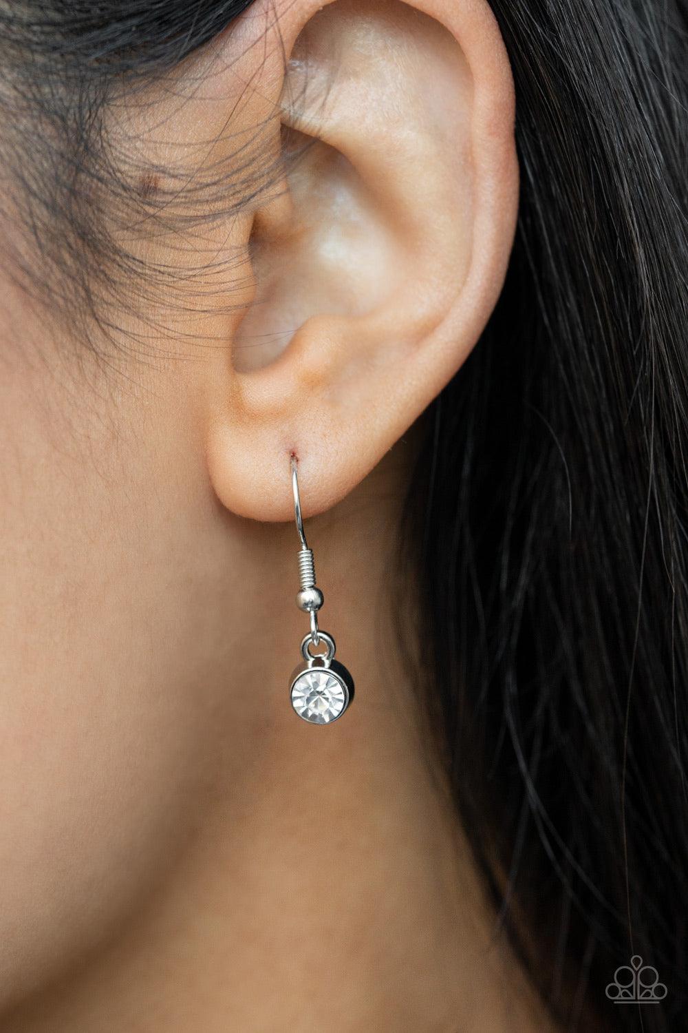 Paparazzi Accessories Long Live Sparkle - White An oversized collection of white emerald cut gems and regally cut clusters of rhinestones delicately link below the collar, creating a dramatically sparkly fringe. Features an adjustable clasp closure. Sold