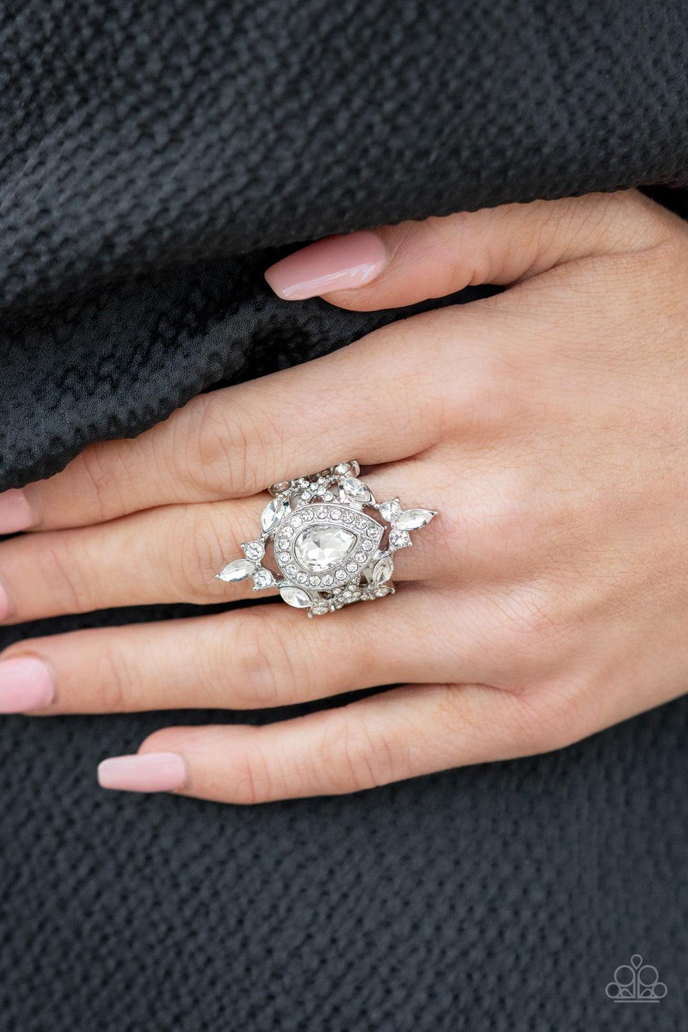 Paparazzi Accessories Mega Stardom - White Featuring classic round and regal marquise cuts, dainty white rhinestones delicately join into a stellar frame. Encrusted in glassy white rhinestones, an oversized teardrop gem sits atop the center of a sparkly b