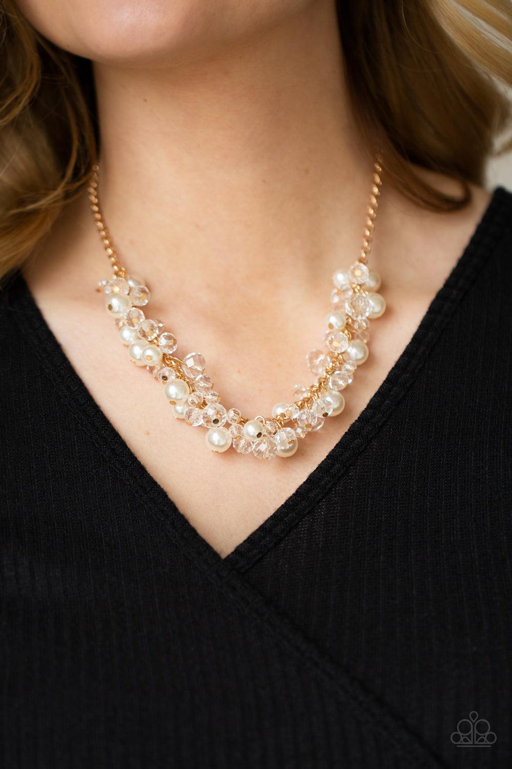Paparazzi Accessories Pardon My FRINGE - Gold A royal collection of classic white pearls and glassy crystal-like beads swing from the bottom of a dainty gold chain, creating a glamorously clustered fringe below the collar. Features an adjustable clasp clo