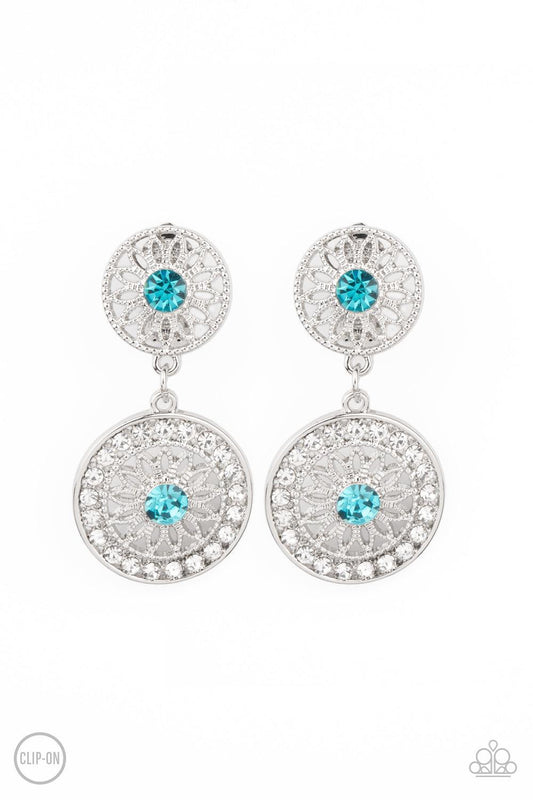 Paparazzi Accessories Life of The Garden Party - Blue *Clip-On Dotted with glittery blue rhinestone centers, shimmery silver floral frames link into a whimsical lure. The lower frame is bordered in glassy white rhinestones for a timeless finish. Earring a