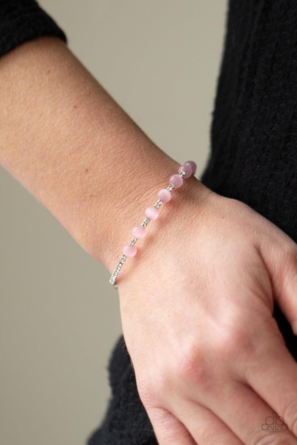 Paparazzi Accessories Tea Party Twinkle - Pink Glassy pink cat's eye stones are fitted in place along a dainty strand of glassy white rhinestones, creating a twinkly cuff around the wrist. Sold as one individual bracelet Jewelry